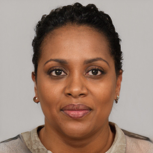 Joyful black young-adult female with short  brown hair and brown eyes