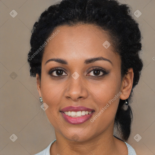 Joyful black young-adult female with long  black hair and brown eyes