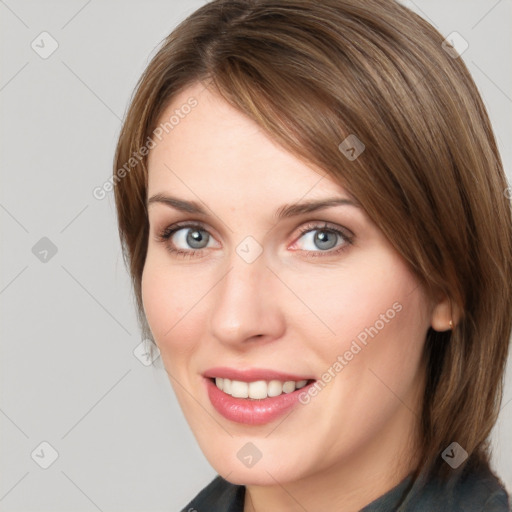 Joyful white young-adult female with medium  brown hair and blue eyes