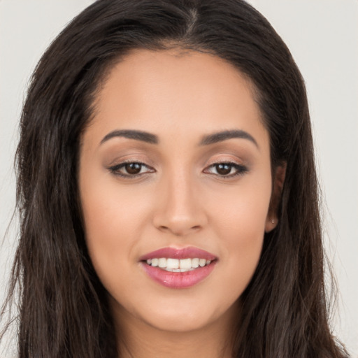 Joyful asian young-adult female with long  brown hair and brown eyes