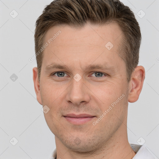 Joyful white adult male with short  brown hair and grey eyes