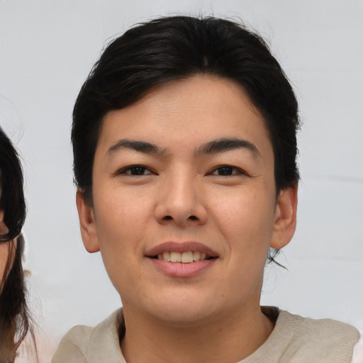 Joyful asian young-adult female with medium  brown hair and brown eyes