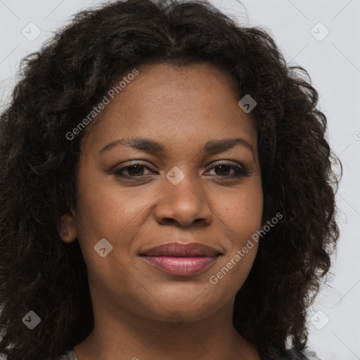 Joyful black young-adult female with long  brown hair and brown eyes