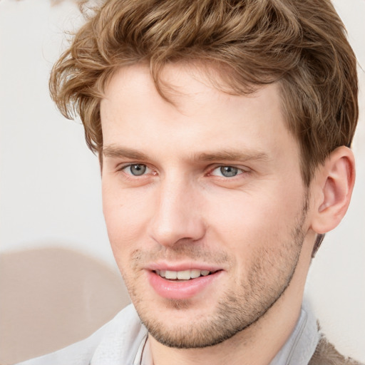 Joyful white young-adult male with short  brown hair and blue eyes