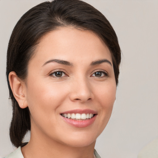 Joyful white young-adult female with medium  brown hair and brown eyes