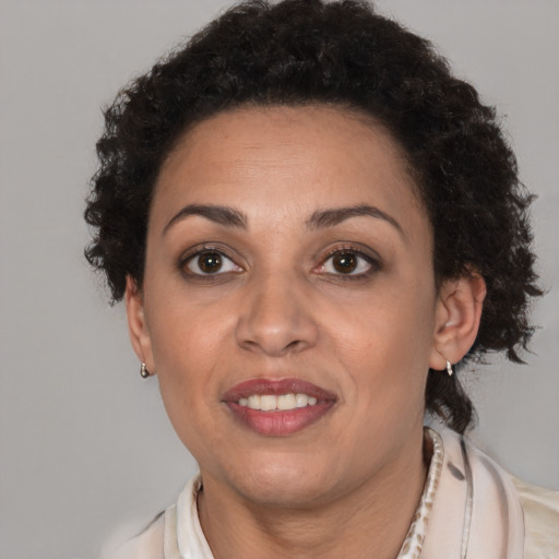 Joyful latino adult female with short  brown hair and brown eyes