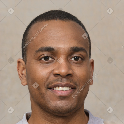 Joyful black young-adult male with short  brown hair and brown eyes