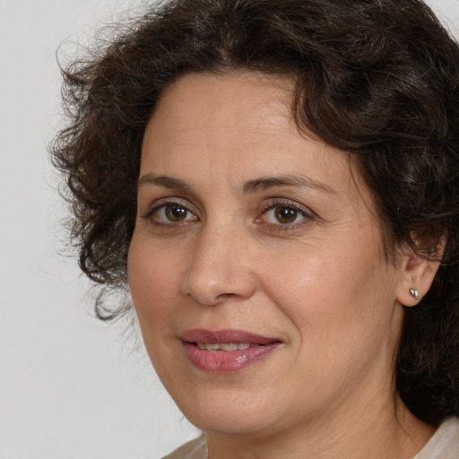 Joyful white adult female with medium  brown hair and brown eyes