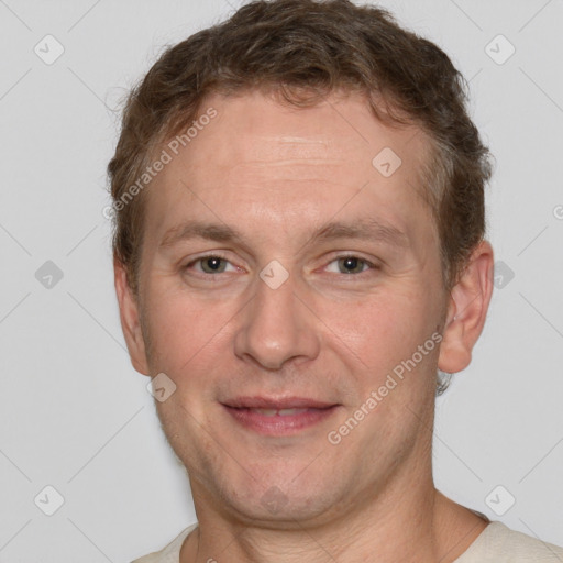 Joyful white adult male with short  brown hair and grey eyes