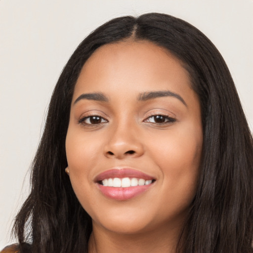 Joyful latino young-adult female with long  black hair and brown eyes