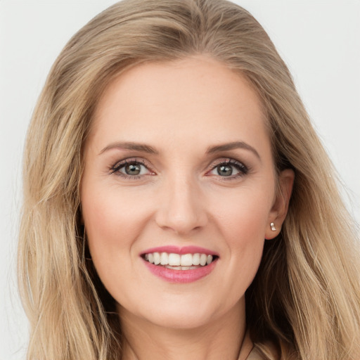 Joyful white young-adult female with long  brown hair and blue eyes