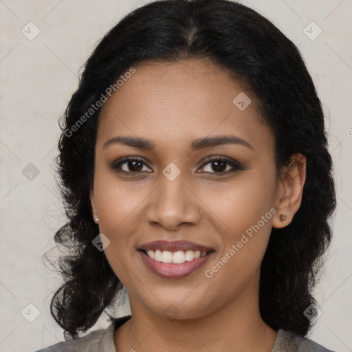 Joyful black young-adult female with long  black hair and brown eyes