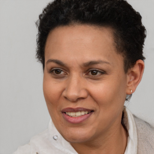 Joyful latino adult female with short  brown hair and brown eyes