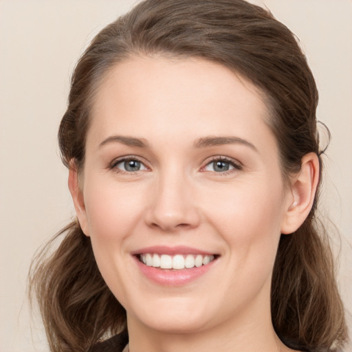 Joyful white young-adult female with medium  brown hair and green eyes