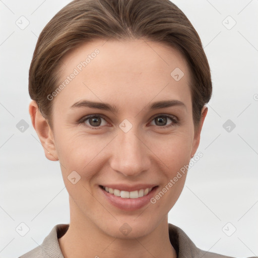 Joyful white young-adult female with short  brown hair and grey eyes