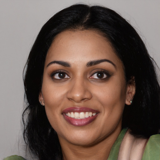 Joyful white young-adult female with long  black hair and brown eyes