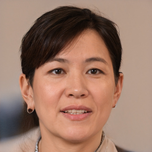 Joyful white adult female with medium  brown hair and brown eyes