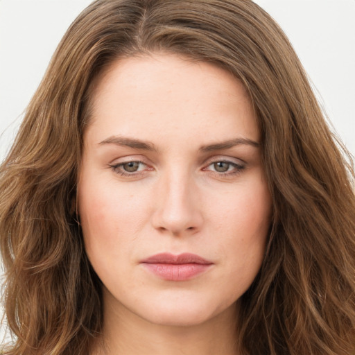 Joyful white young-adult female with long  brown hair and green eyes