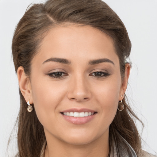 Joyful white young-adult female with long  brown hair and brown eyes