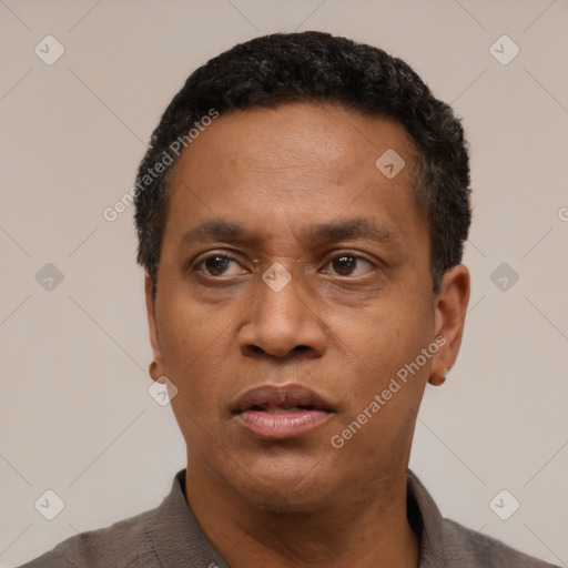 Neutral latino adult male with short  black hair and brown eyes