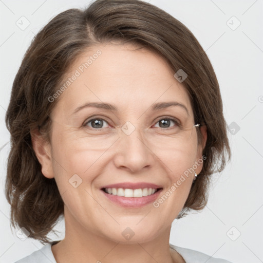 Joyful white adult female with medium  brown hair and grey eyes