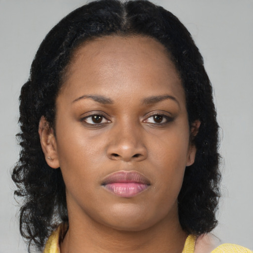 Neutral black young-adult female with medium  brown hair and brown eyes