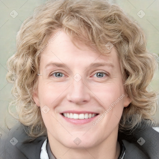 Joyful white adult female with medium  brown hair and blue eyes