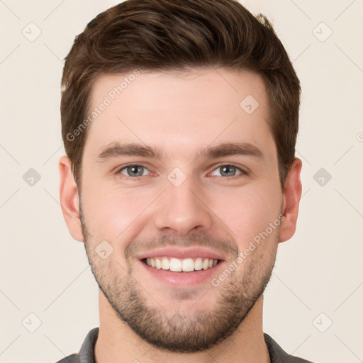 Joyful white young-adult male with short  brown hair and grey eyes