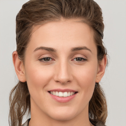 Joyful white young-adult female with long  brown hair and grey eyes