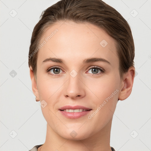 Joyful white young-adult female with short  brown hair and grey eyes