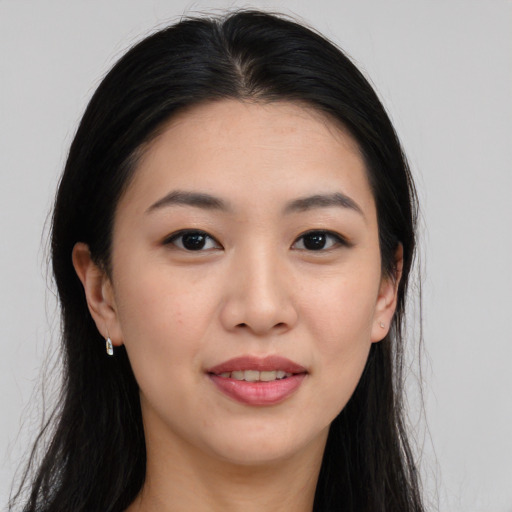 Joyful asian young-adult female with long  brown hair and brown eyes