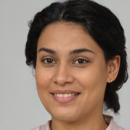 Joyful latino young-adult female with medium  brown hair and brown eyes