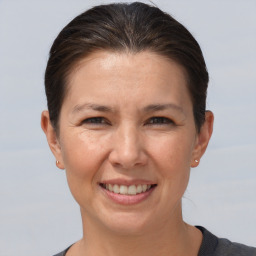 Joyful white adult female with short  brown hair and brown eyes