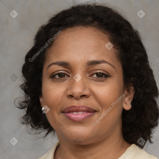 Joyful black adult female with medium  brown hair and brown eyes