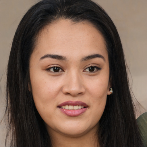 Joyful asian young-adult female with long  brown hair and brown eyes