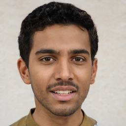 Joyful latino young-adult male with short  black hair and brown eyes