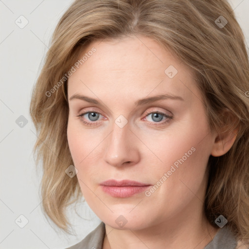 Joyful white young-adult female with medium  brown hair and blue eyes