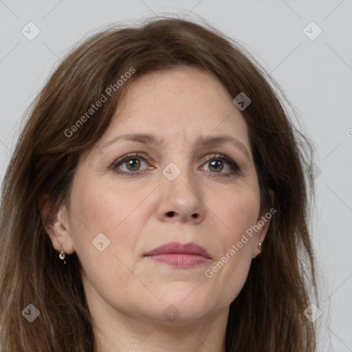 Joyful white adult female with long  brown hair and grey eyes