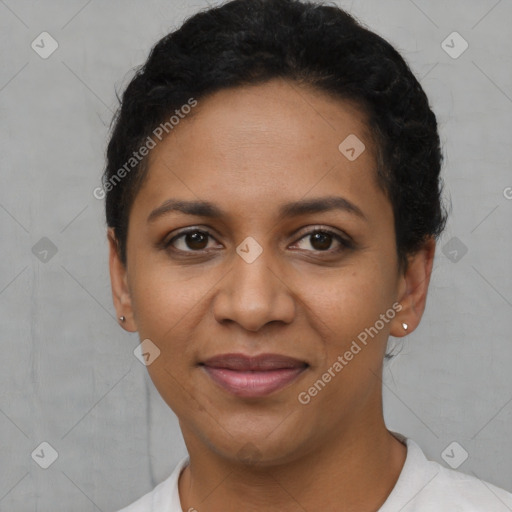 Joyful black young-adult female with short  black hair and brown eyes