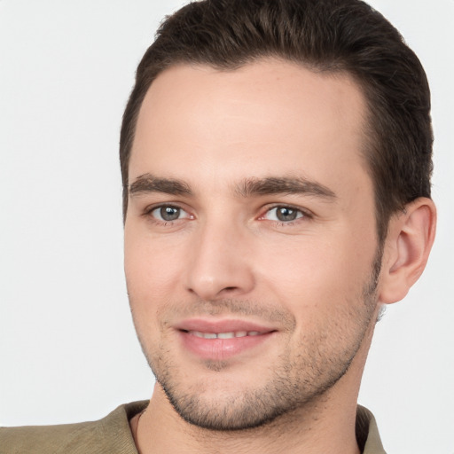 Joyful white young-adult male with short  brown hair and brown eyes