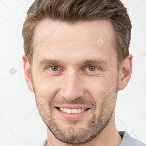 Joyful white adult male with short  brown hair and grey eyes