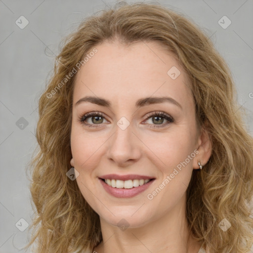 Joyful white young-adult female with long  brown hair and green eyes