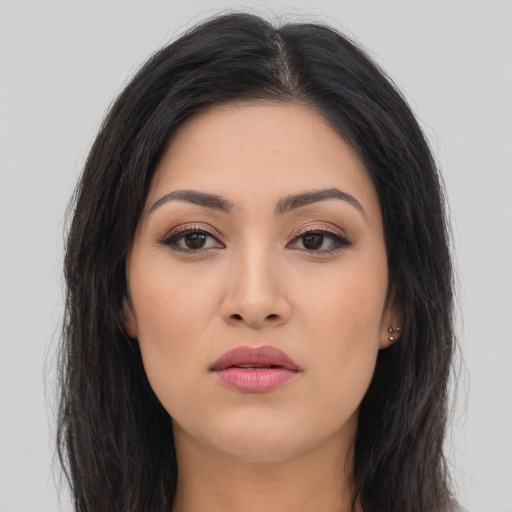 Joyful asian young-adult female with long  brown hair and brown eyes
