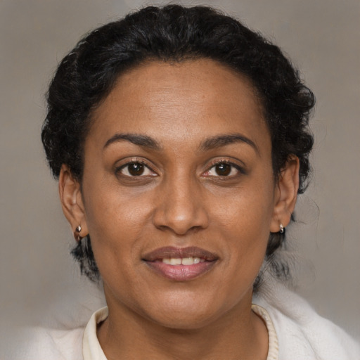 Joyful latino adult female with short  brown hair and brown eyes