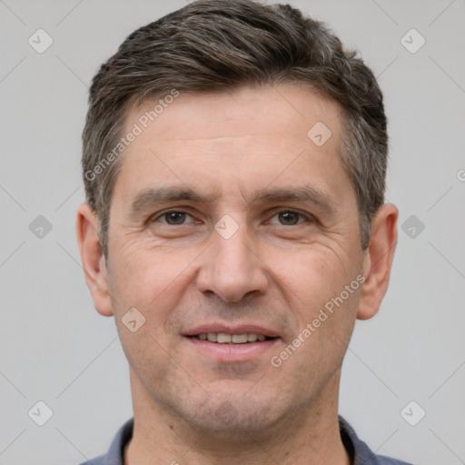 Joyful white adult male with short  brown hair and grey eyes