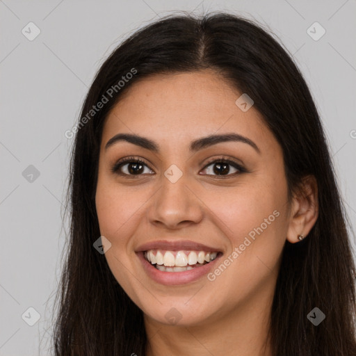 Joyful latino young-adult female with long  brown hair and brown eyes