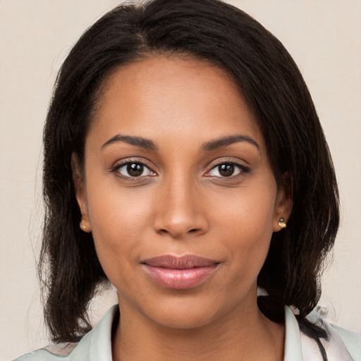 Joyful black young-adult female with medium  brown hair and brown eyes