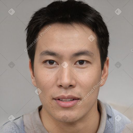 Joyful asian young-adult male with short  brown hair and brown eyes