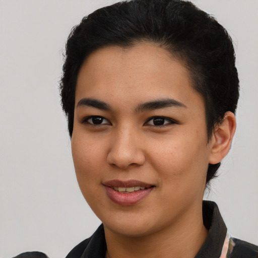 Joyful latino young-adult female with short  black hair and brown eyes