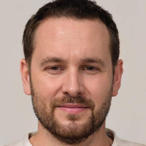 Joyful white adult male with short  brown hair and brown eyes